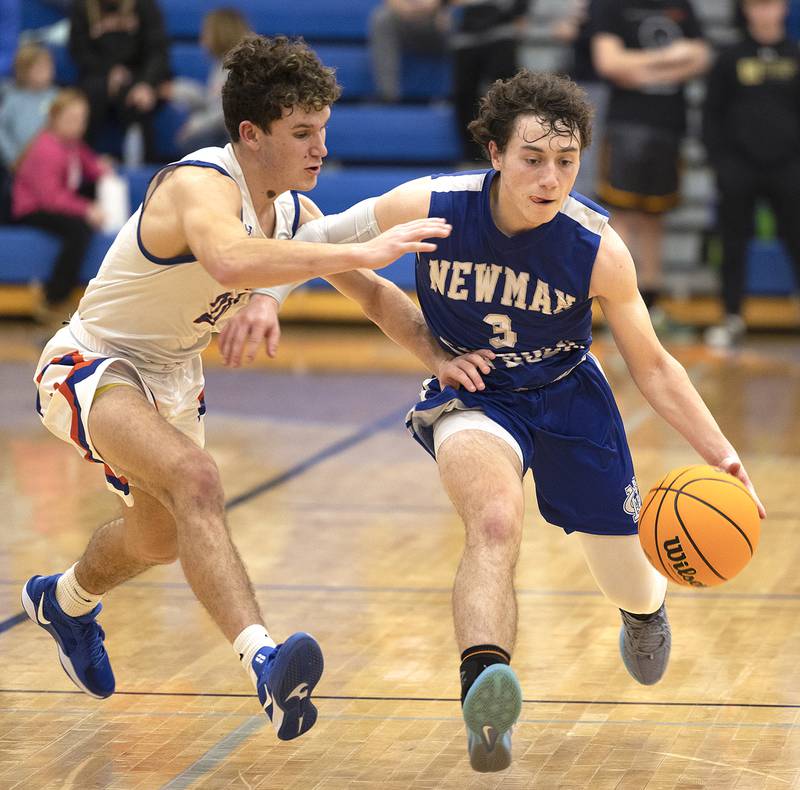Newman’s Garret Matznick handles the ball against Eastland’s Peyton Spears Tuesday, Dec. 10, 2024, at Eastland High School.