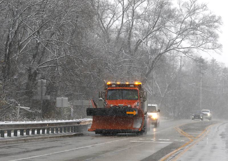 A snow plow travels along West Johnsburg Road on Tuesday, Nov. 15, 2022. The McHenry County area received its first measurable snowfall of the season on Tuesday.