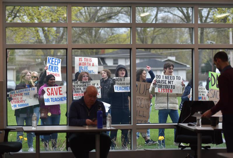 St. Charles North High School students protest outside as the District 303 school board meeting is being set up at Haines School in St. Charles on Monday, April 17, 2023. They were protesting the involuntary reassignment of several teachers.