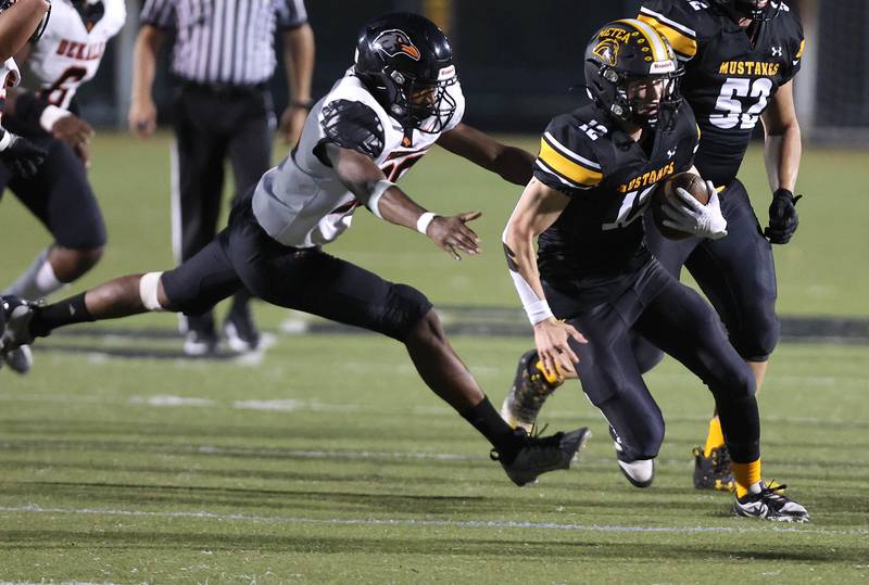 Metea Valley's Lucas Van Vlerah scrambles away from DeKalb’s Justin O’Neal during their game Friday, Sept 15, 2023, at Metea Valley High School in Aurora.