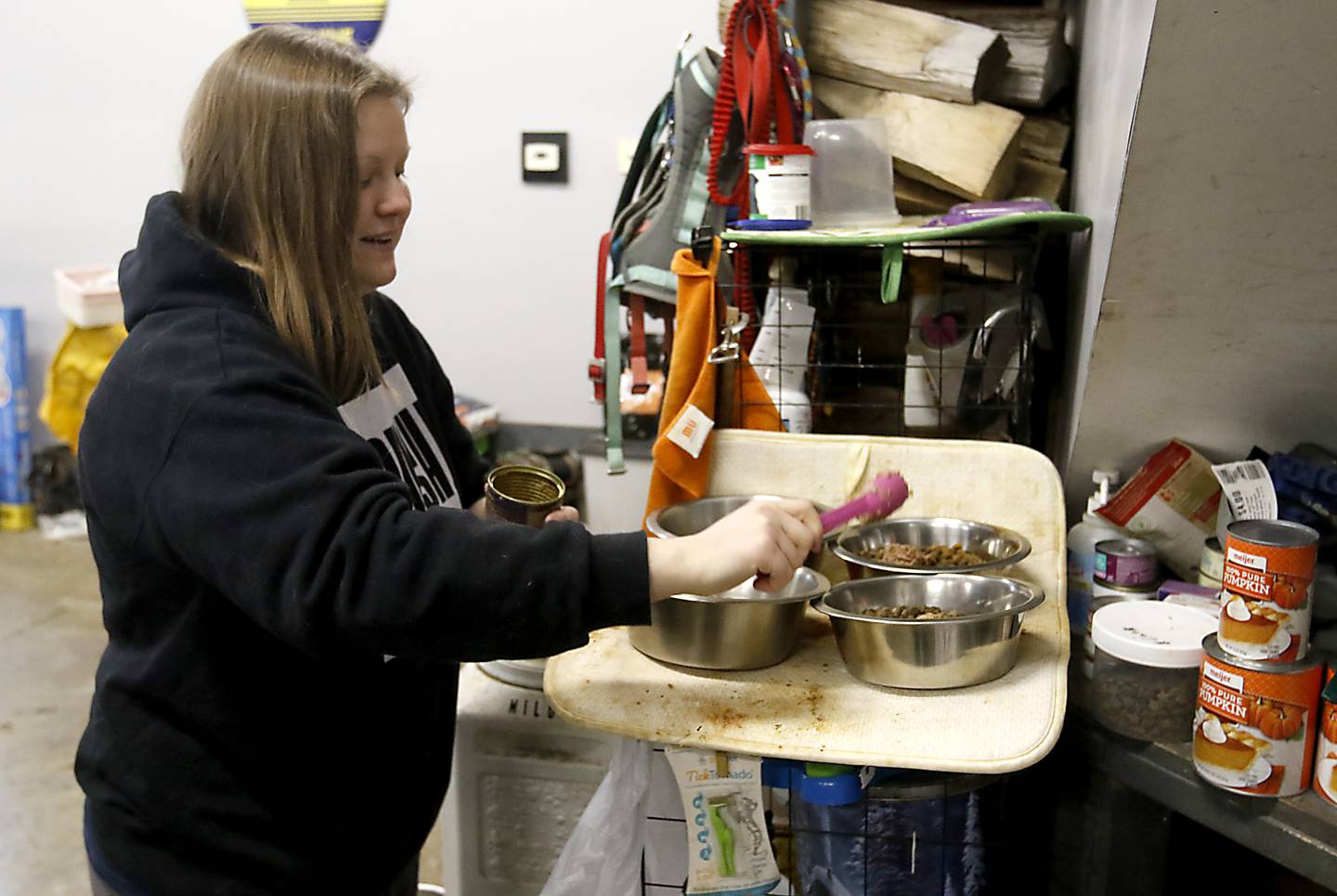 Hanna Kowal prepare dinner for her sled dogs on Tuesday, Dec. 20, 2022, at her home near Hebron. Kowal trains and races sled dogs while also working and going to college.