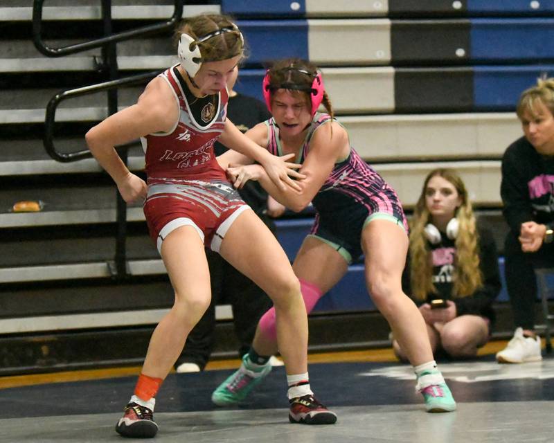 Veronica Skibicki of Lockport, left, escapes from Eva Hermansson of Woodstock in the 110-weight class championship match on Saturday Jan. 4, 2025, where Veronica took a 4-3 decision during the Aaron Dundley invite held at Oswego East High School.