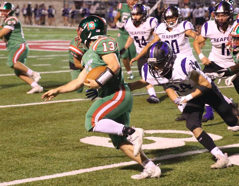 L-P's Brady Romagnoli runs the ball down the field as Plano's Tristan Meszaros looks to bring him down on Friday, Sept. 15, 2023 at Howard Fellows Stadium.