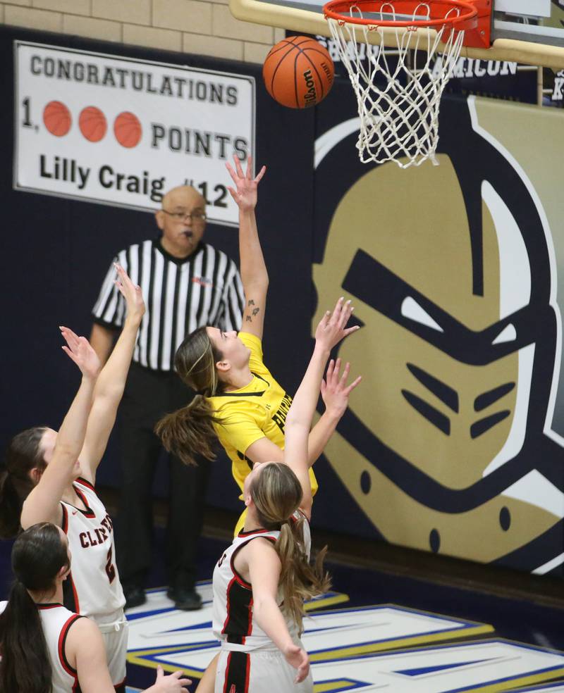 Putnam County's Ava Hatton dribbles between Amboy defenders Addison Pertell, Kiera Karlson and Maeve Larson to score on a layup during the Class 1A Regional semifinal game on Monday, Feb. 12, 2024 at Marquette High School.