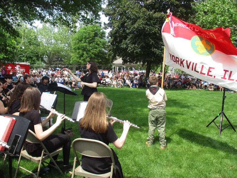 Julie Fischer leads the Yorkville Middle School Band while flags were fluttering in the wind during Yorkville Memorial Day ceremonies on May 30, 2022 in Town Square Park (Mark Foster -- mfoster@shawmedia.com)