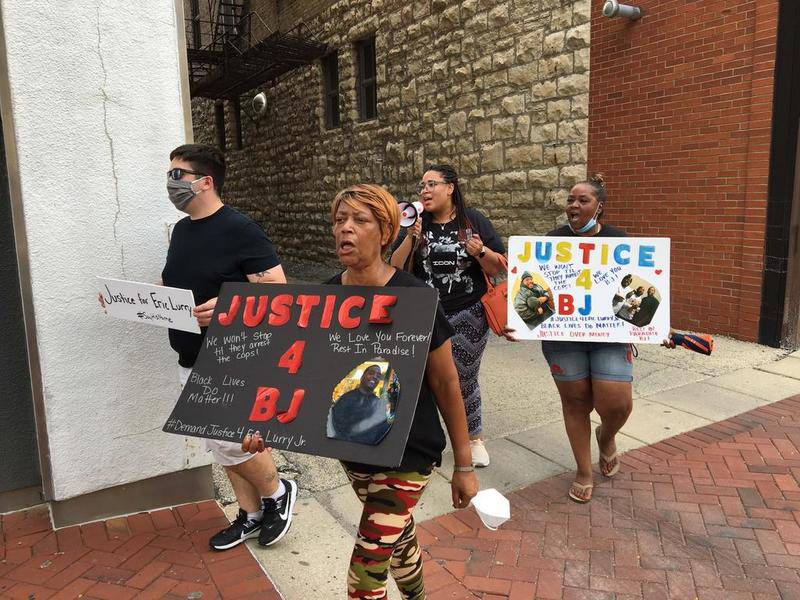 Demonstrators protest against Will County State's Attorney James Glasgow on Monday in downtown Joliet in response to the death of Eric Lurry Jr.