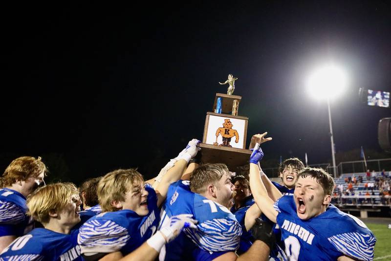 Princeton raises the traveling trophy after defeating Kewanee, 37-14, Friday night in the 125th meeting of the longtime rivals.