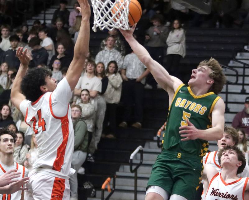 Crystal Lake South’s  Carson Trivellini, right, shoots as McHenry’s Adam Anwar defends in varsity boys basketball on Friday, Feb. 20, 2026, at McHenry High School in McHenry.