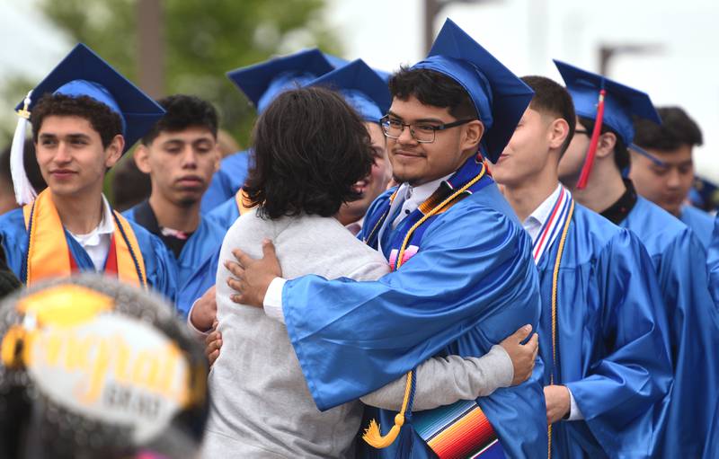 Jasso hugs a friend before the start of the graduation ceremony on Saturday, May 21 at the Now Arena in Hoffman Estates.