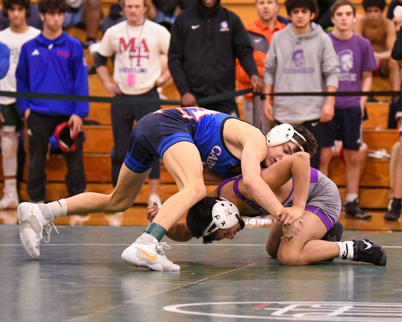 Nicholas Garcia of Marmion Academy, left, tries to control Tyler Tiancgo of Downers Grove North where Nicolas took the regional win in the 113 weight class on Saturday Feb. 3, 2024, held at Glenbard West High School.