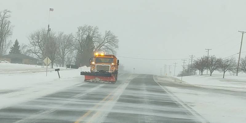 A snow plow clears drifts from the west lane of Illinois Route 26 south of Dixon on Wednesday morning.