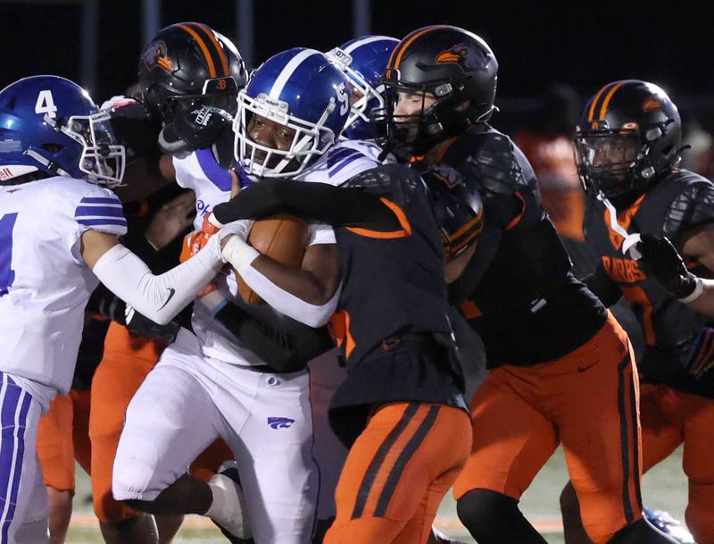 Phillips' Ameen Robinson is brought down by a host of DeKalb defenders Friday, Sept. 5, 2025, during their game at DeKalb High School.
