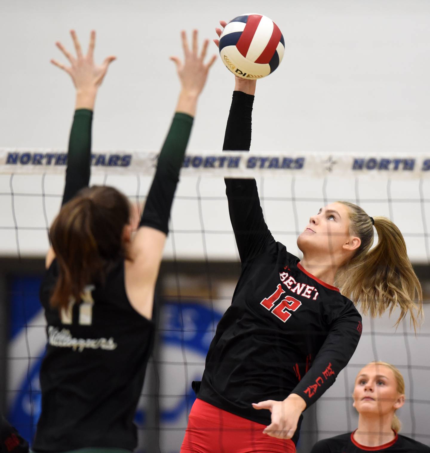 Joe Lewnard/jlewnard@dailyherald.com
Benet AcademyÕs Lynney Tarnow, right, leaps for a kill in front of Glenbard WestÕs Kayla Street during the Class 4A girls volleyball sectional final at St. Charles North Wednesday.