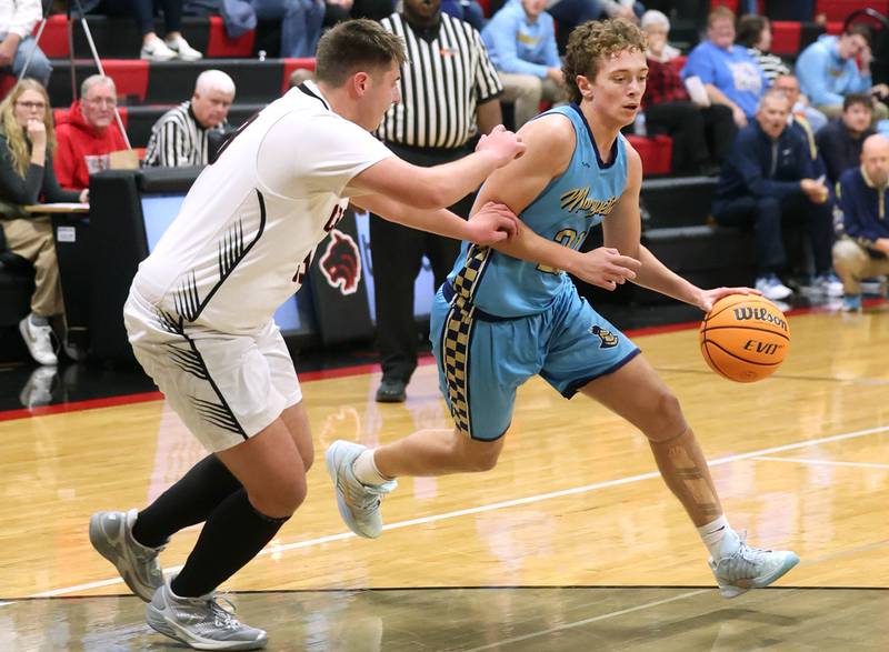 Marquette’s Lucas Craig tries to drive around Indian Creek's Payton Hueber Monday, Dec. 9, 2025, during their game at Indian Creek High School in Shabbona.