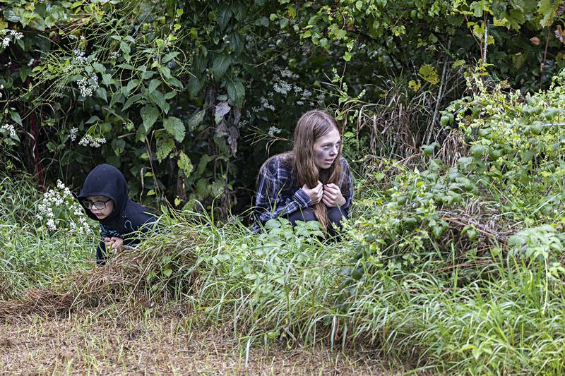Lurking behind one last turn, Johannes Como, 3, and Kendall Como, 15, wait to spring out on runners Saturday, Sept. 16, 2023.