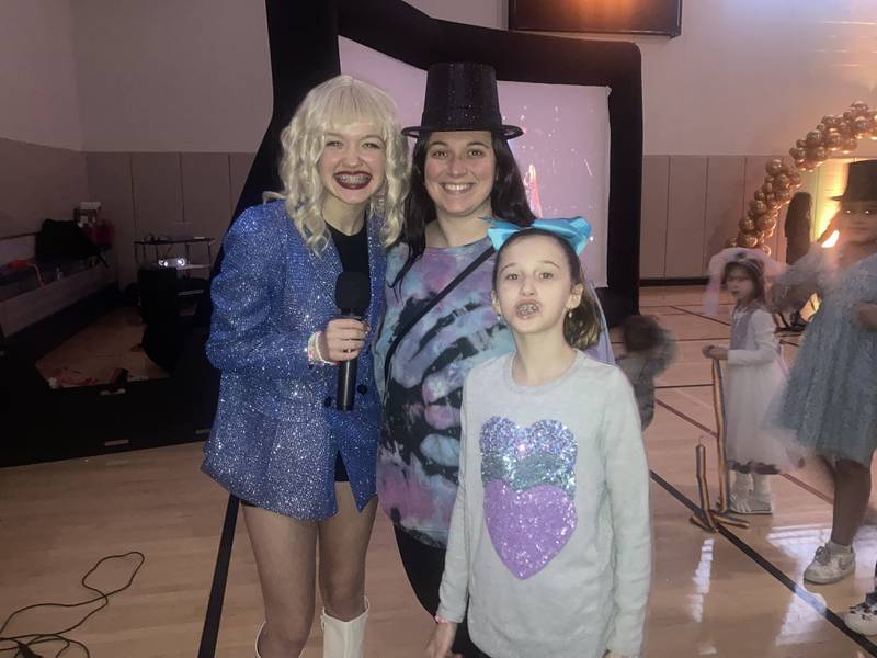 Raffle winner Katie Jones poses with her daughter Paypon Jones and "Taylor Swift."