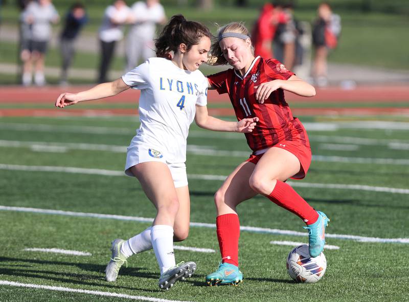 Hinsdale Central's Peyton Rohn (11) goes for the ball against Lyons Township's Niamh Griffin (4) during the girls varsity soccer match between Lyons Township and Hinsdale Central high schools in Hinsdale on Tuesday, April 18, 2023.