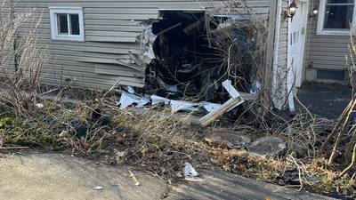 Photos: Stolen car crashes into Crystal Lake home