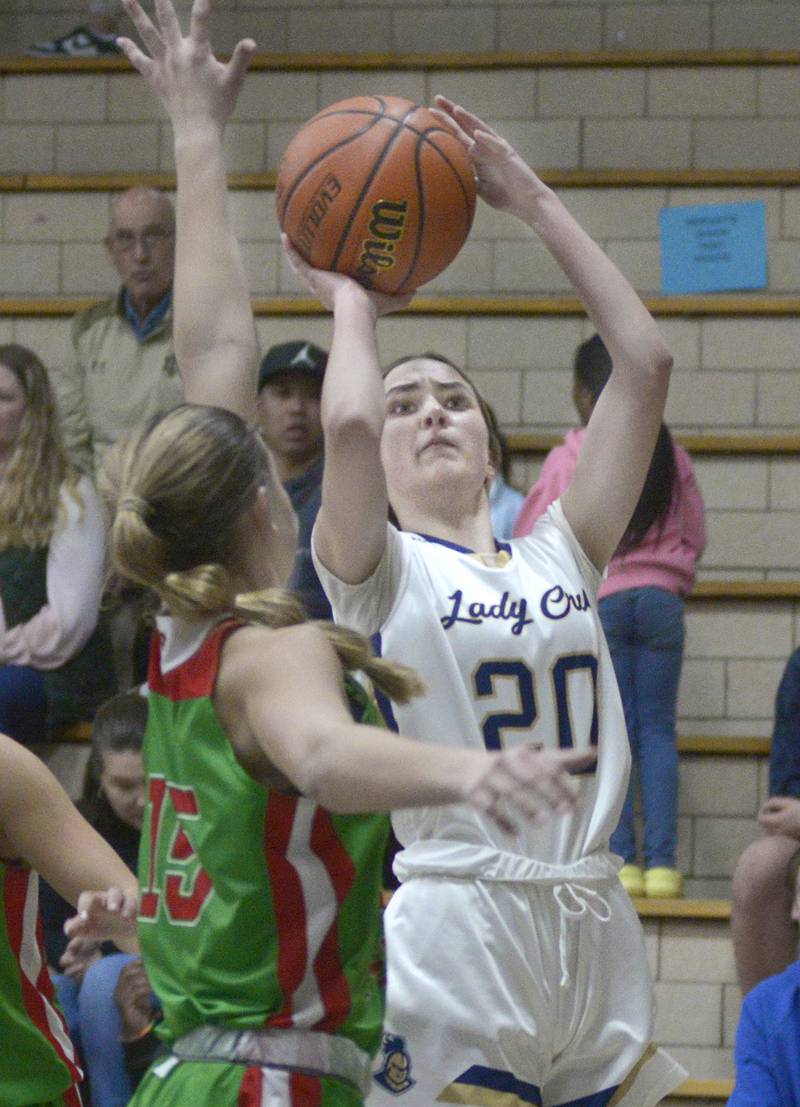 Marquette’s Kaitlyn Davis works to get a shot past the La Salle-Peru defender Kelsey Frederick at the game in Ottawa Wednesday.