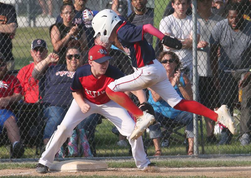 Ottawa American's Mason Collins tags out Streator's Brody Daugheridy at third base during the District 20 championship game on Sunday, July 14, 2024 at Washington Park in Peru.