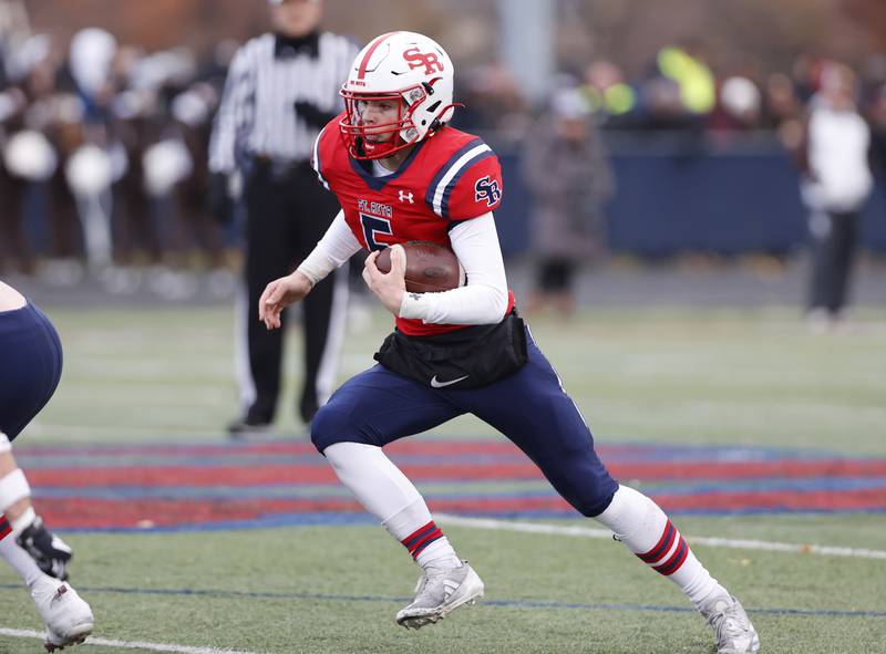 St. Rita's Steven Armbruster (5) runs the ball during the class 7A semi-final playoff game between Mt. Carmel and St. Rita high schools on Saturday, Nov. 23, 2024 in Chicago.