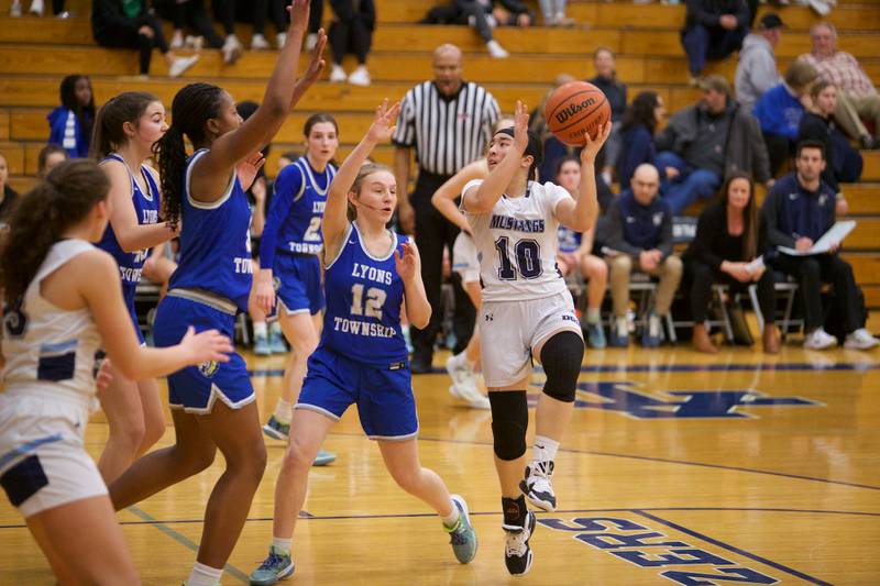 Downers Grove South's Elizabeth Rous goes in for the layup against Lyons Avery Mezan at the West Suburban Conference Crossover Championship on Wednesday, Feb.8,2023 in Addison.