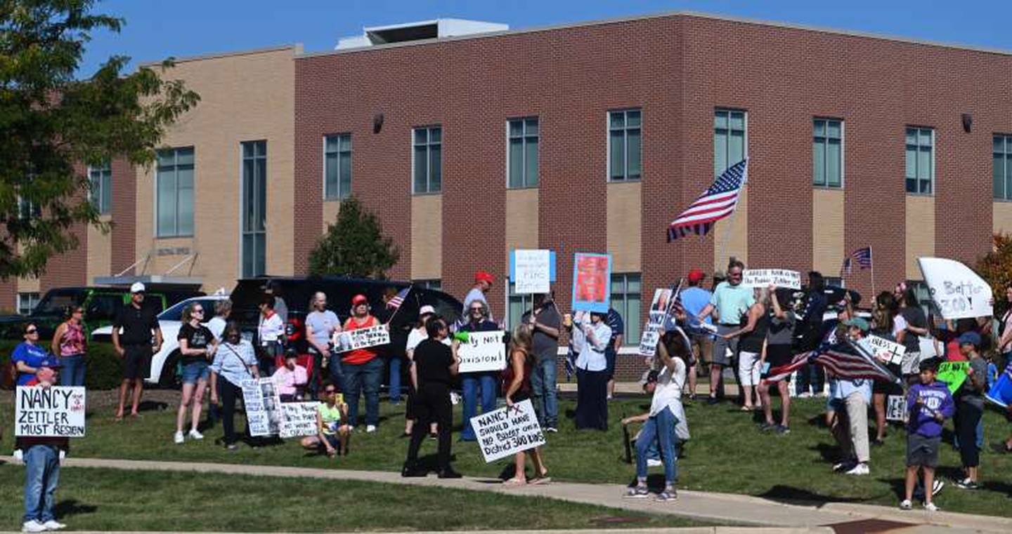 About 60 people participated in a protest on Monday, Sept. 15, 2025, at District 300 headquarters in Algonquin, demanding that school board president Nancy Zettler step down following a social media post related to the shooting death of activist Charlie Kirk.