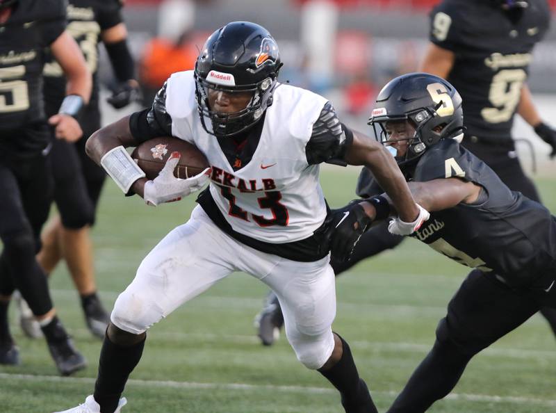 DeKalb’s Davon Grant gets away from Sycamore's Tyler Curtis during the First National Challenge game Friday, Aug. 25, 2023, in Huskie Stadium at Northern Illinois University in DeKalb.