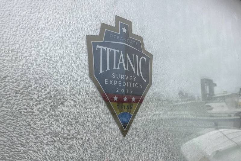 FILE - The logo for an OceanGate Expeditions 2019 Titanic expedition is seen on a marine industrial warehouse office door in Everett, Wash., Tuesday, June 20, 2023. Rescuers are racing against time to find the missing submersible carrying five people, who were reported overdue Sunday night. (AP Photo/Ed Komenda, File)