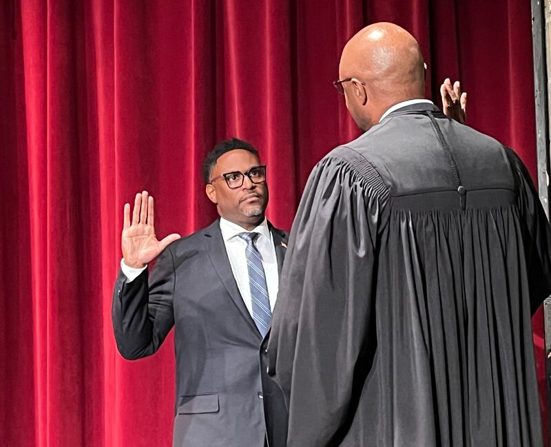 Antione Edwards (left) sworn into office as Joliet Township trustee by Will County Judge Vincent Cornelius on Tuesday, Oct. 10, 2023.