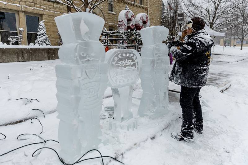 Max Zuleta, of Art Below Zero, crafts a Lockport-themed ice sculpture outside Lockport City Hall during Lockport’s Christmas in the Square festivities on Nov. 29, 2025.