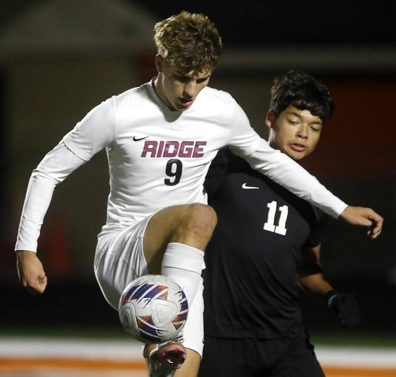 McHenry's Nelson Rodriguez controls the ball in front of McHenry's Yahel Garcia during a Fox Valley Conference soccer match on Tuesday, Oct. 15, 2024, at McCraken Field in McHenry.
