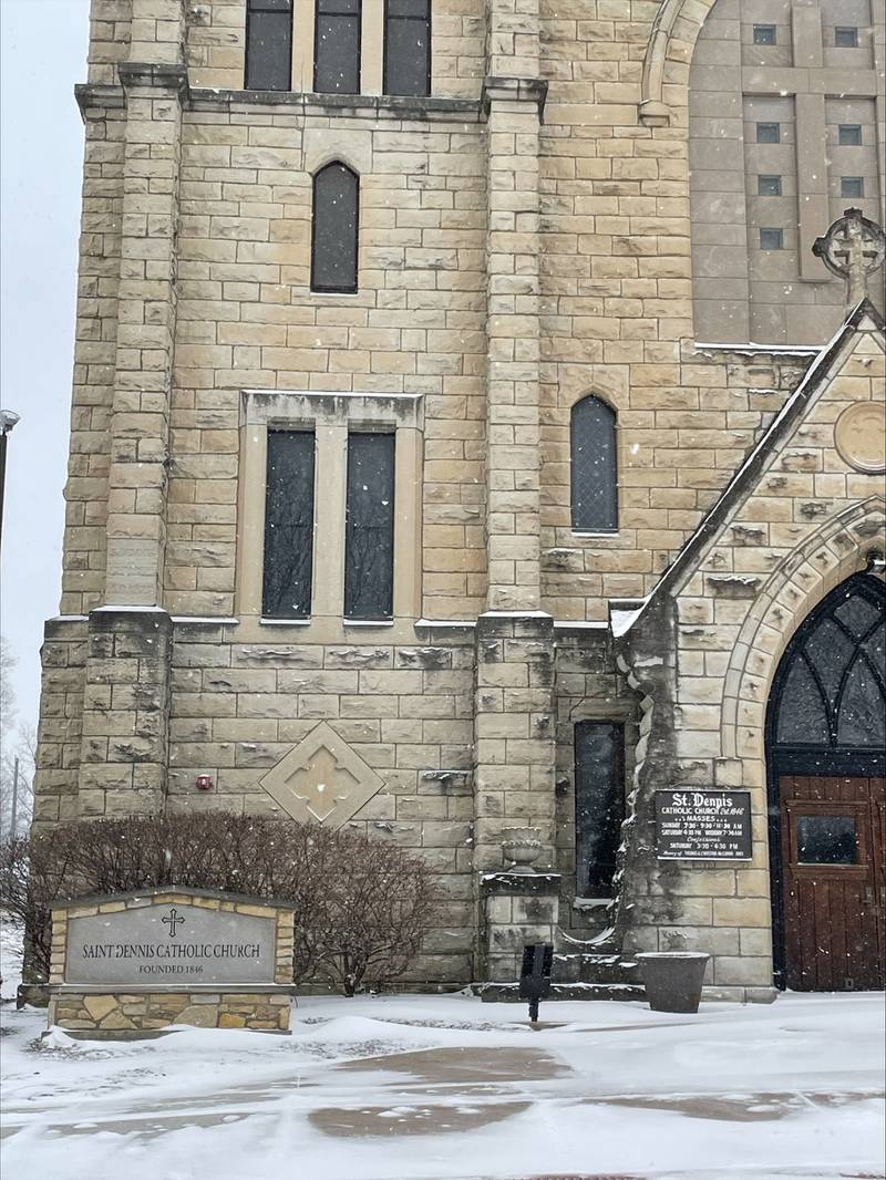 St. Dennis Church sits silently as a wintry mix of snow and sleet comes down on Wednesday, Feb. 12, 2025.