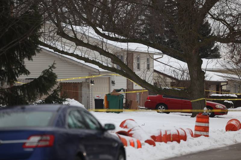 A home is taped off along West Acres Road at the scene were multiple people were found dead in two homes on Monday, Jan. 22nd in Joliet.