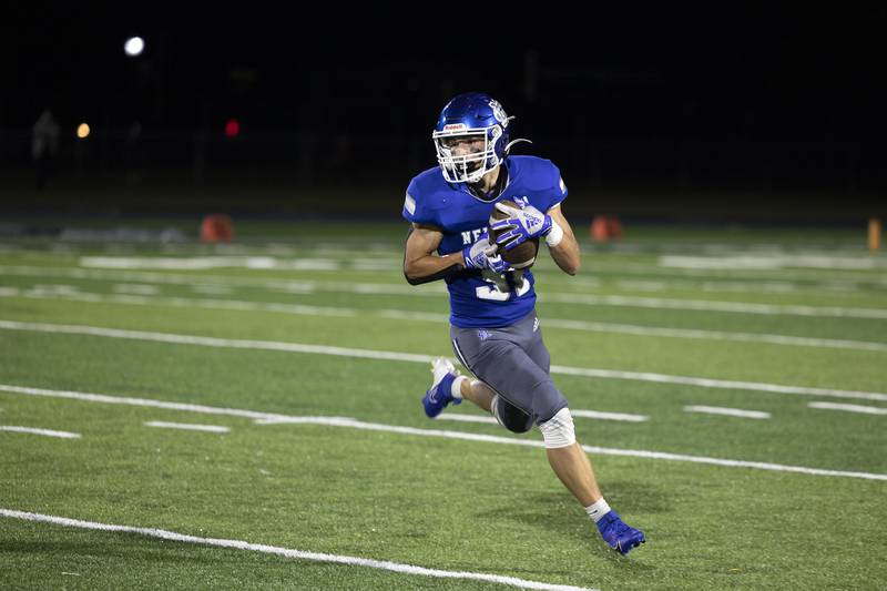 Newman’s Cody McBride looks for yards after hauling in a pass against Rockridge Friday, Sept. 27, 2024, in Sterling.
