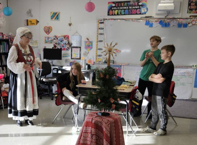 Cross Lutheran School's fourth graders ended their Christmas Around the World unit with a presentation by Barb Johnson, left, on Christmas in Norway.