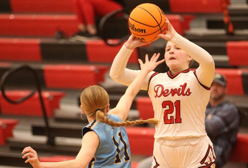 Hall's Ava Delphi lets go of a shot over Marquette's Keely Nelson on Thursday, Feb. 13, 2025 at Hall High School.