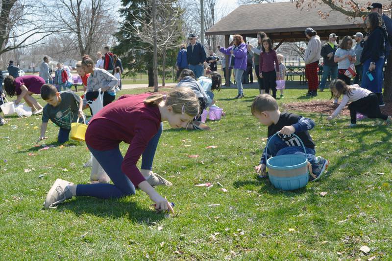 Kelly Stauffer, 10, of Forreston, and Wes Byers, 3, of Cedarville, gather candy and prizes during an Easter egg hunt in Forreston's Memorial Park on April 8, 2023. The Forreston Lions Club and Forreston Area Business Association sponsored the annual Easter egg hunts and a Touch-A-Truck event.