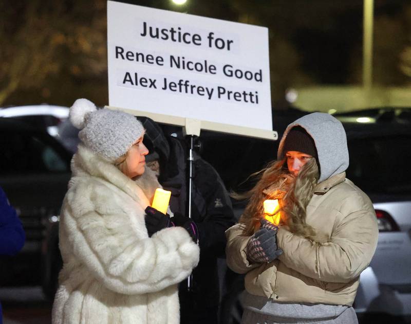 Attendees hold candles Monday, Jan. 26, 2026, during a vigil outside the DeKalb County Legislative Center in Sycamore after second shooting death in Minnesota involving ICE officers.
