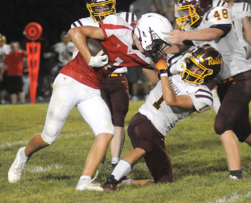 Streator's Matt Wiliamson (7) and East Peoria's Joe Clark grab each other's face mask at Deiken Stadium on Friday, Aug. 25, 2023.