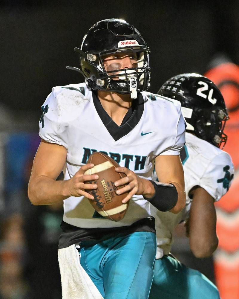 Woodstock North's Parker Halihan looks for an open receiver against Kishwaukee River Conference and crosstown rival Woodstock on Friday, Oct. 25, 2024 at Woodstock H.S.