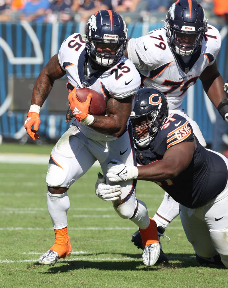 Denver Broncos running back Samaje Perine is tackled by Chicago Bears defensive tackle Andrew Billings during their game Sunday, Oct. 1, 2023, at Soldier Field in Chicago.