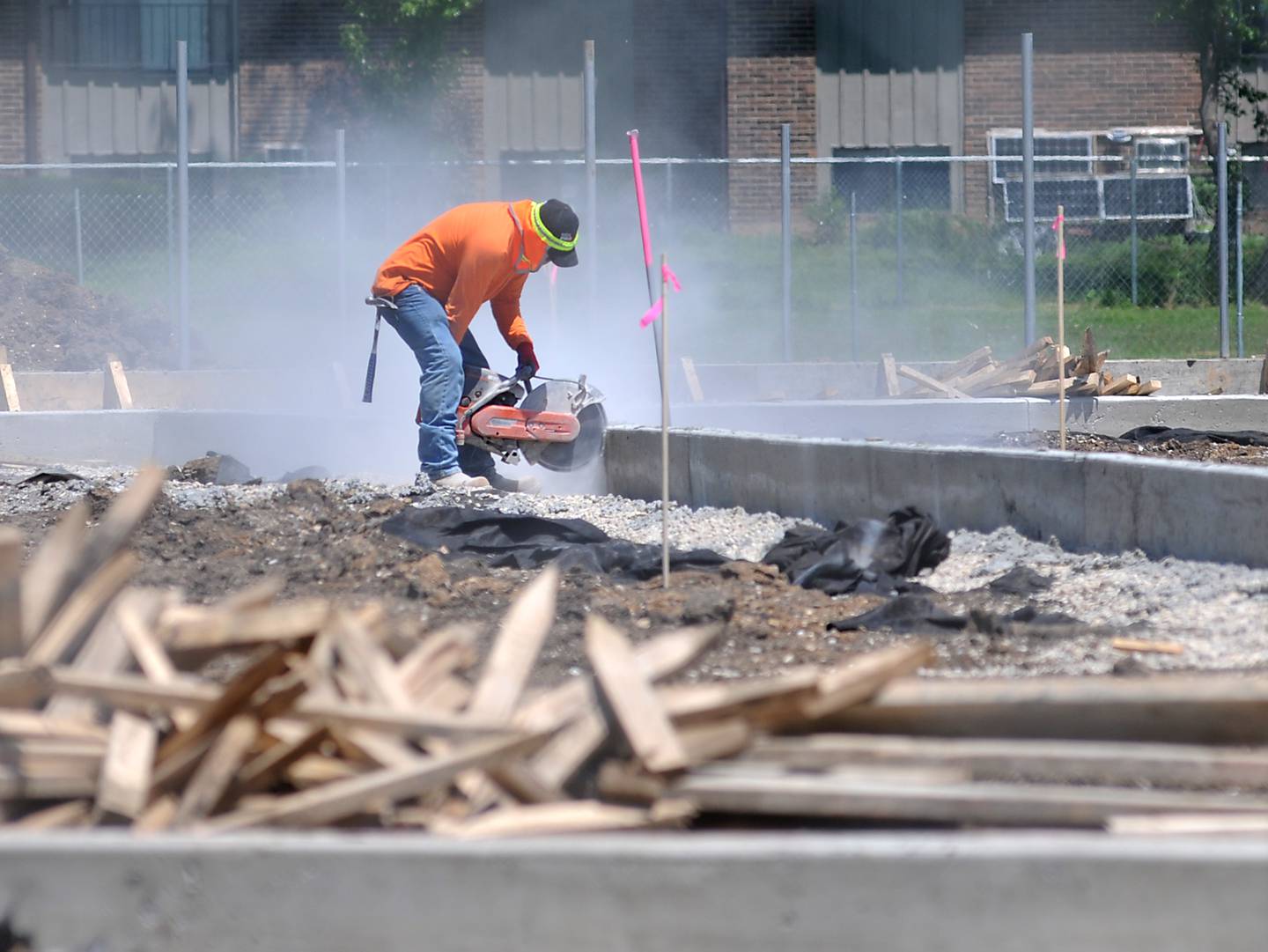 A worker from Herrera Construction works on cutting concrete Tuesday, June 14, 2022, while working on upgrading McCracken Athletic Field in McHenry.