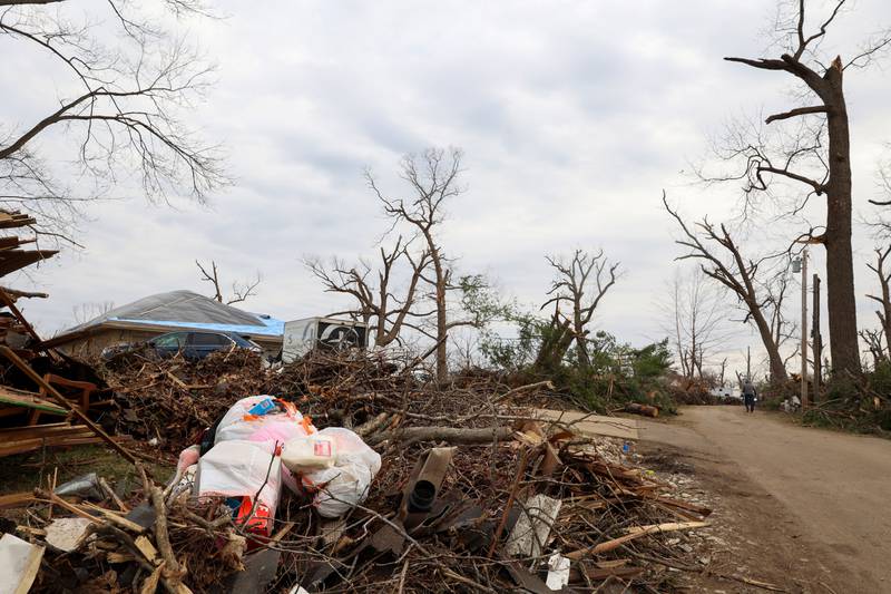 Trash and debris pile up along Elmwood Drive in Aroma Township on March 14, 2026, following the March 10 tornado in Kankakee County.