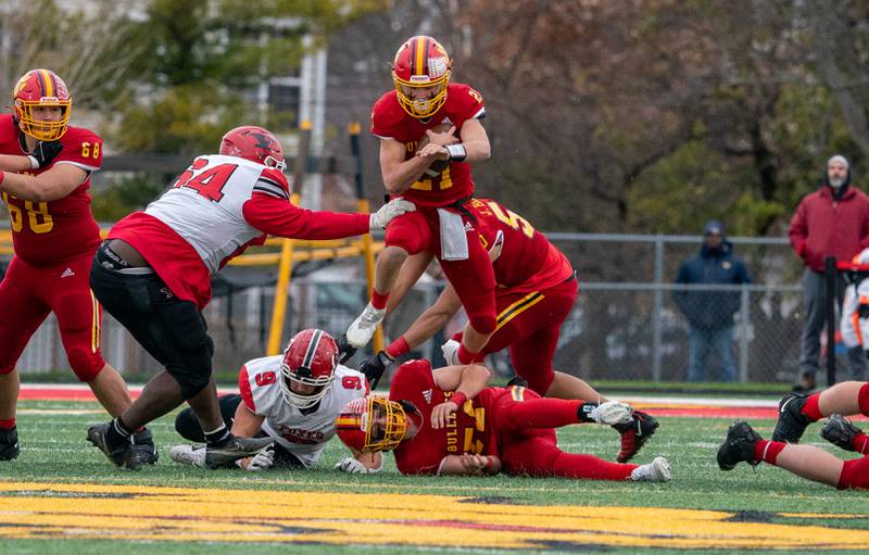 Batavia’s Ryan Boe (21) runs on the keeper and leaps over Jack David (52) during a 7A quarterfinal playoff football game against Yorkville at Batavia High School on Saturday, Nov 12, 2022.
