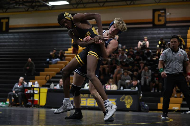Plainfield South’s Sean Volf throws Joliet West’s Giovanni Baker in the 138 pound match on Wednesday, Dec. 3, 2025 in Joliet.