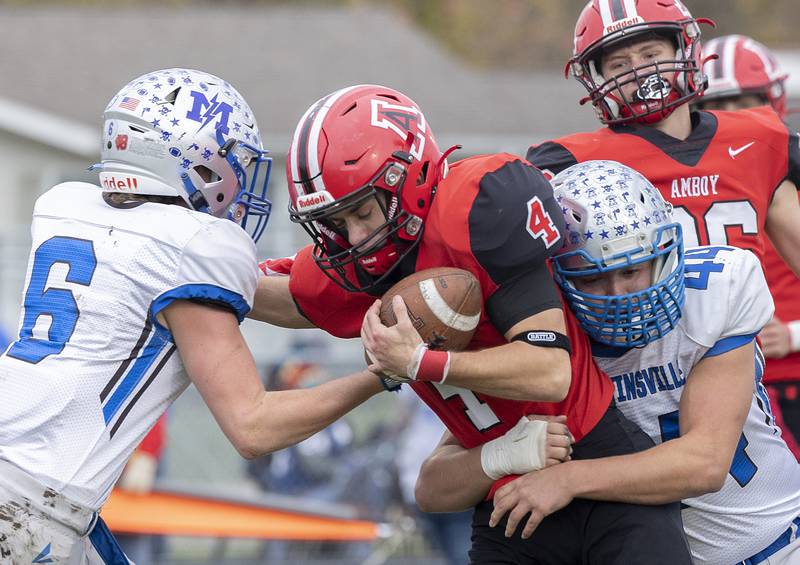 Amboy’s Josh McKendry fights for yards against the Martinsville defense Saturday, Nov. 9, 2024, in round two of the 8-man football playoffs.