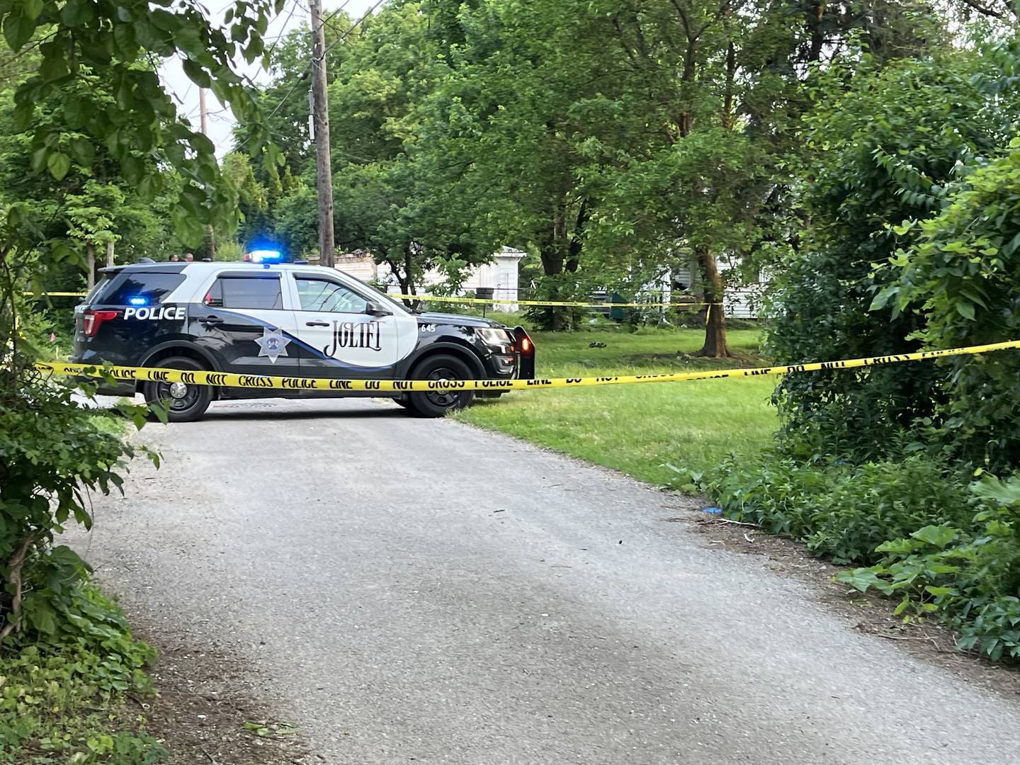 A Joliet Police Department squad vehicle posted in a blocked-off alley on Monday, June 2, 2025, where a 13-year-old boy was found dead from gunshot wounds in Joliet.