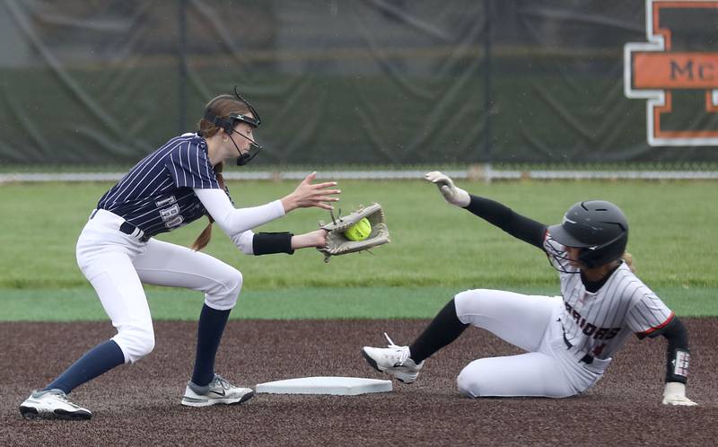 Cary-Grove's Ella Grimm tries to tag McHenry's Hailey Townsend as she slides into second base during a Fox Valley Conference softball game on Thursday, April 30, 2026, at McHenry High School.