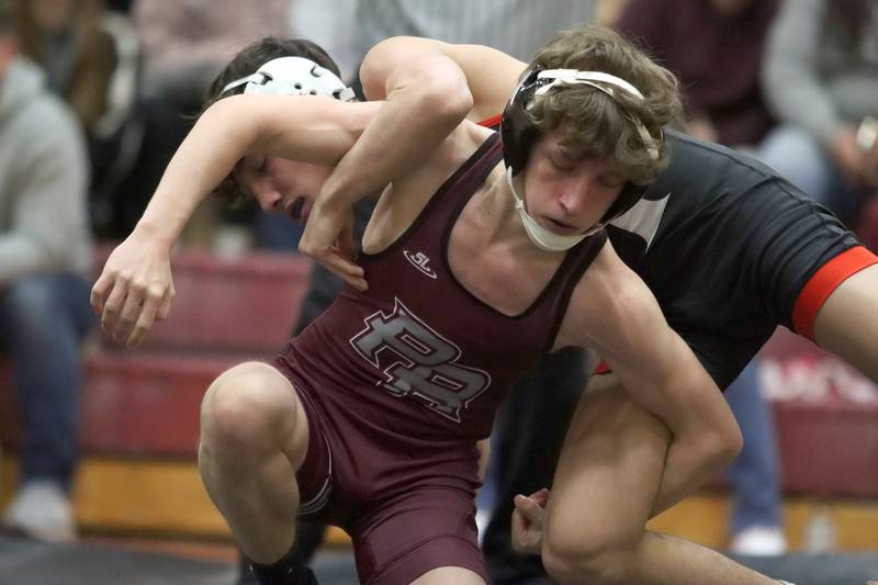 Huntley’s Colin Abordo, back, battles Prairie Ridge’s Johnny Cabano at 113 pounds in varsity wrestling on Thursday, Jan. 23, 2025, at Huntley High School in Huntley.